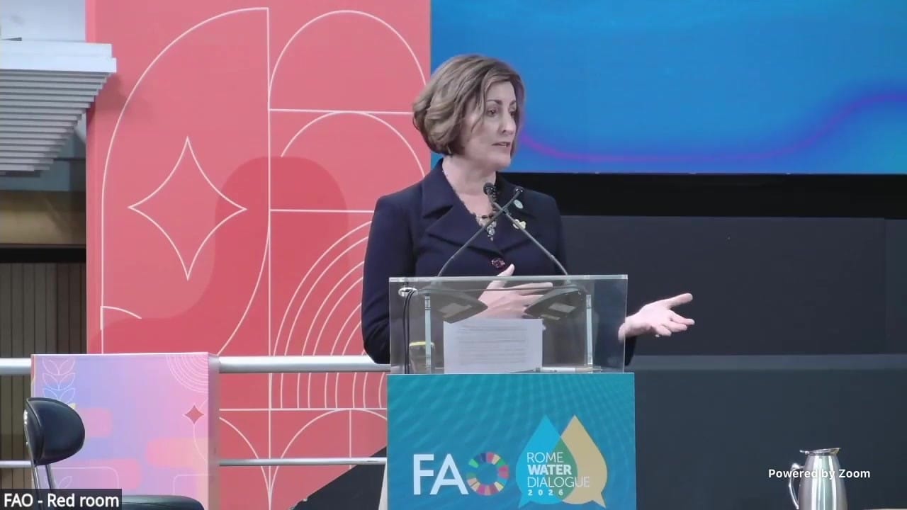 Beth Bechdol speaking at the podium in FAO's Red Room